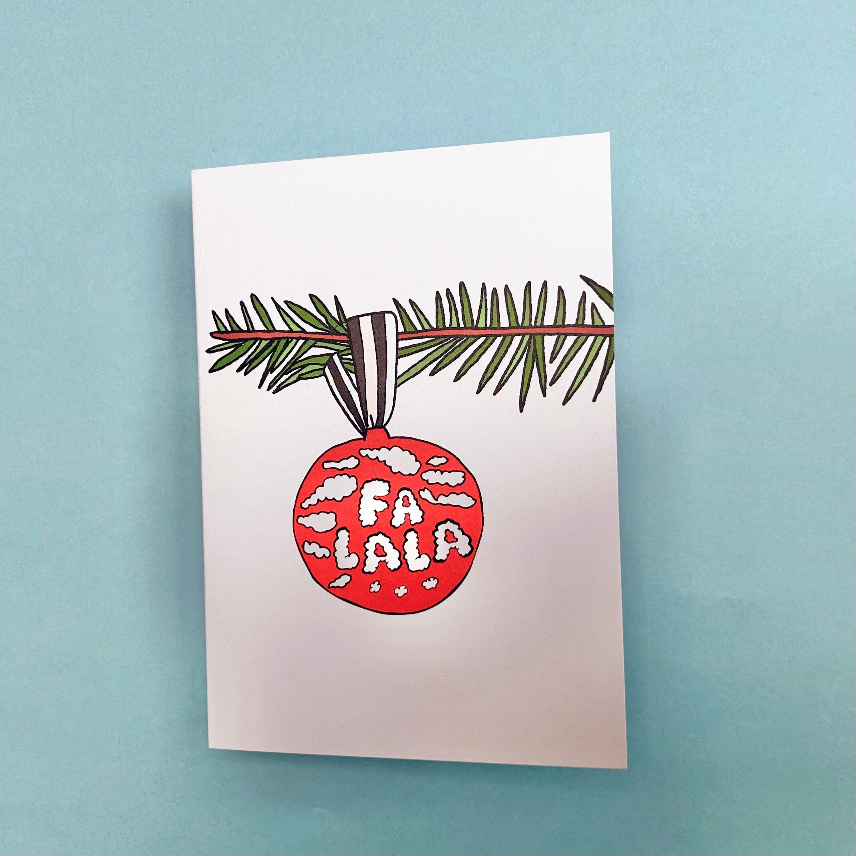 Hand drawn illustration of a Christmas Tree sprig and a red bauble with the words Fa La La in bubble writing on it. Printed on a plain white card. 