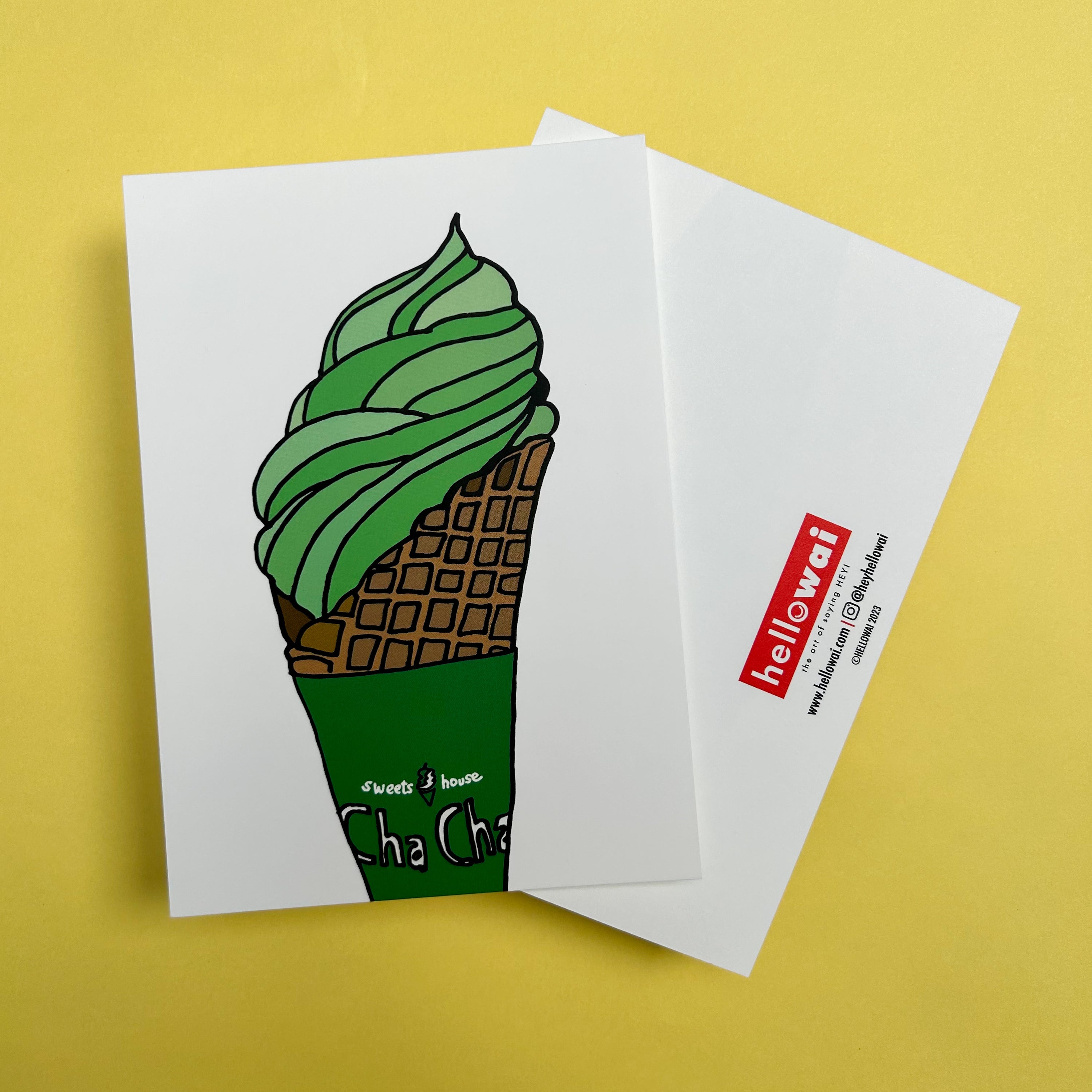 Front and back view of an A6 Hello Wai flat notecard. Front has colour illustration of a matcha flavoured soft serve ice cream in a waffle cone with a green cone wrapper. Back has the Hello Wai logo.