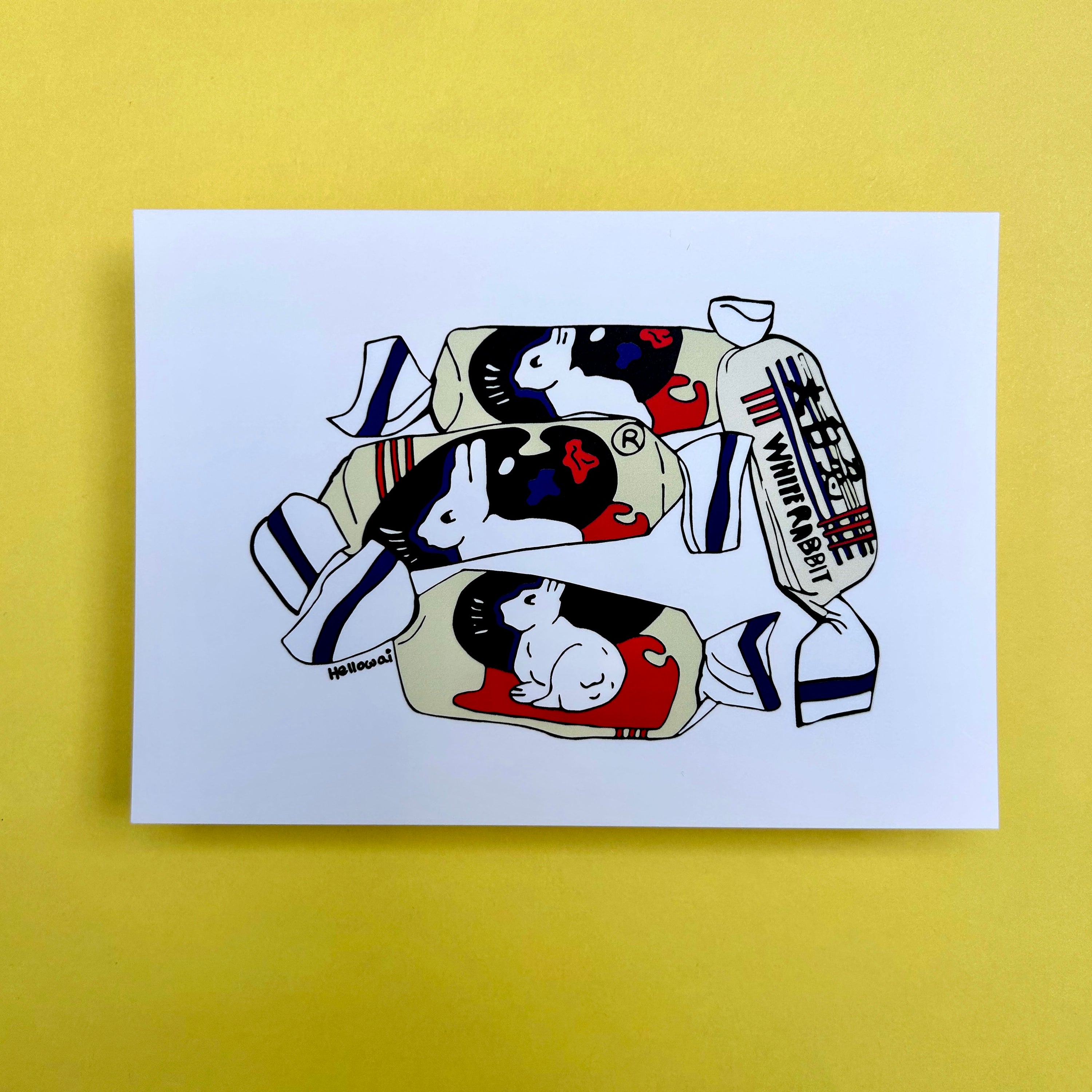 An A6 Hello Wai flat notecard with a colour illustration of four White Rabbit Candies in their wrappers, printed on white card. 